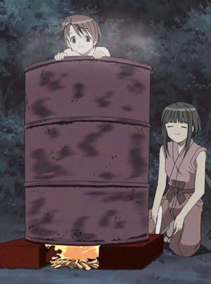 Lady bathing inside a drum of water. Lady bathing inside a drum of water.