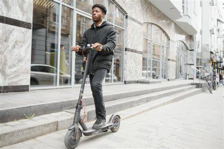 Man goes on scooter ride with girlfriend